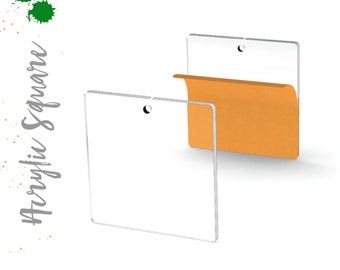 May include: Two clear acrylic squares with a hole in the top. The square on the right has a folded orange paper behind it.