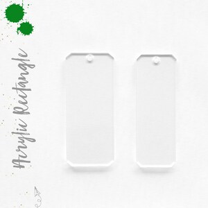May include: Two clear acrylic rectangle shapes with rounded corners and a hole at the top. The shapes are on a white background.