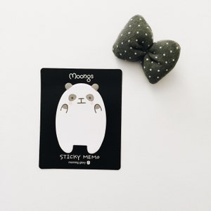 May include: Black and white panda sticky note memo pad with the text "Moongs Sticky Memo morning glory" on the front.