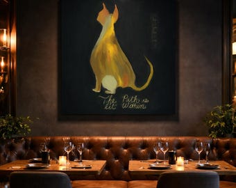 May include: A large square canvas displays a stylized painting of a dog in shades of yellow and orange against a black background. The text "The Path is lit Within" is written in gold script below the dog. The artwork hangs above a leather booth.