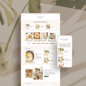May include: A website design mockup featuring the "LILLIA ROSE" brand, displayed on a laptop and a smartphone. The design showcases a clean, minimalist aesthetic with soft beige and white tones, and includes the text "your go-to place for a daily dose of wellness, healthy recipes & balanced living."