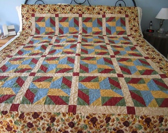 Sun Flowers, rust, blue, gold, green, quilt, blanket, handmade, hand pieced, used as a twin or double size, machine quilted, tan pasley