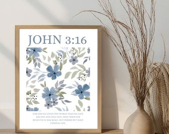 Può includere: Una stampa incorniciata con il testo "JOHN 3:16" in blu chiaro. L'opera presenta un motivo floreale con fiori blu e foglie verdi. Un versetto biblico è stampato in basso. La cornice è di colore marrone chiaro.
