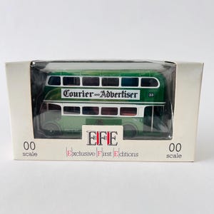 May include: A green and white model double-decker bus with the words "Courier and Advertiser" on the side. The bus is in a box with the words "EFE Exclusive First Editions 00 scale" on the bottom.