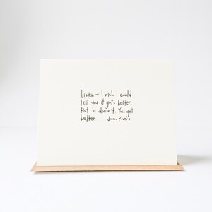 May include: A white card with a handwritten quote by Joan Rivers: "Listen - I wish I could tell you it gets better. But it doesn't. You get better."