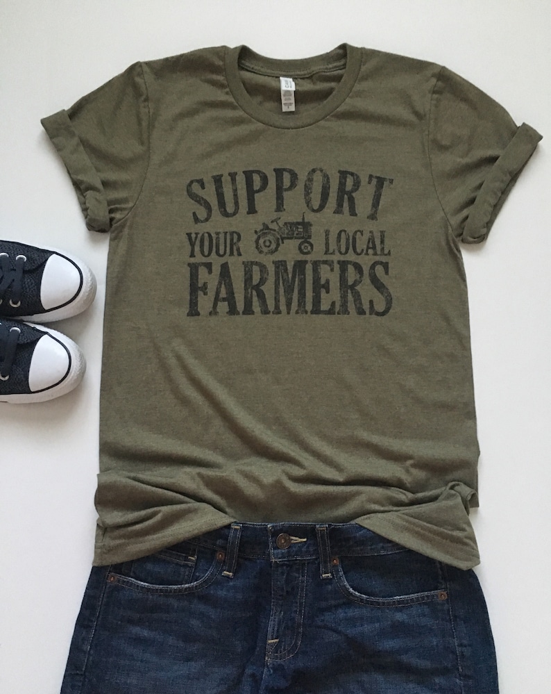 May include: A green t-shirt with the text "Support Your Local Farmers" and a black silhouette of a tractor.