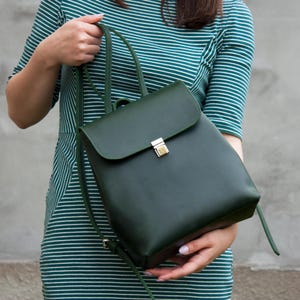 Op de afbeelding: Een witte keramische mok met een zwart handvat en de tekst "But First, Coffee" in een vetgedrukte, zwarte letter. De mok staat tegen een neutrale achtergrond, wat het eenvoudige ontwerp benadrukt.