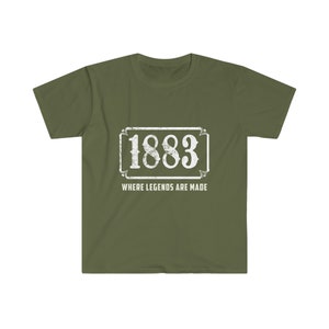 May include: A green t-shirt with a white vintage-style sign that says "1883 Where Legends Are Made".