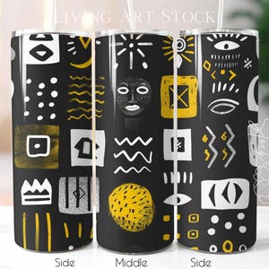 May include: Three cylindrical tumblers with a black background featuring a repeating pattern of white and gold abstract shapes, including eyes, geometric squares, wavy lines, dots, and a stylized face, with a clear straw protruding from each top.