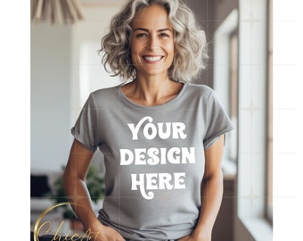 Middle Aged Smiling Woman with White, Gray Hair Wearing Gray Crewneck T-shirt Mockup with White Living Room Background | Mockup Photos