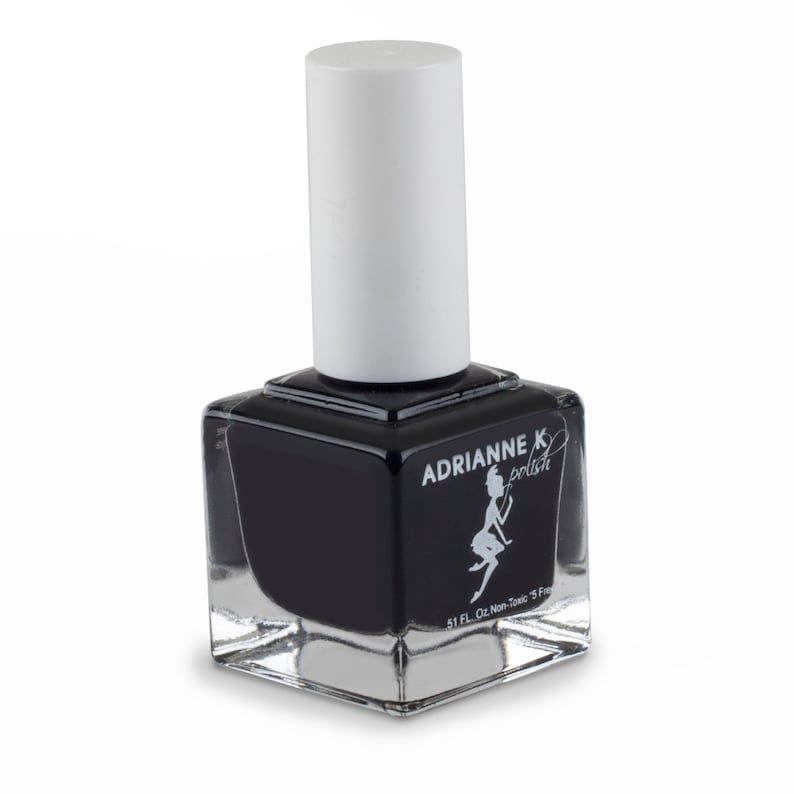 May include: A clear glass bottle of black nail polish with a white cap. The bottle has a label that says "Adrianne K polish" and a small illustration of a fairy. The label also says "5.1 FL. Oz. Non-Toxic 5 Free".