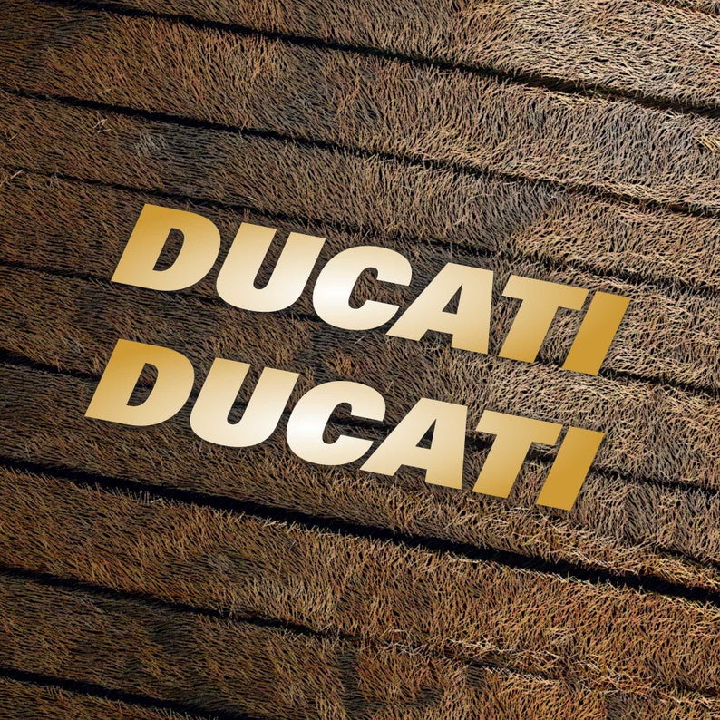 May include: The word "DUCATI" is written twice in gold letters on a brown, textured background.