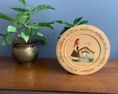 Vintage wooden hand painted plate from Bulgaria farm scene woman with pitcher and bird vibrant colors