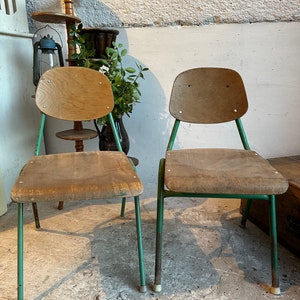 May include: Two vintage wooden chairs with green metal frames. The chairs have a simple design and are in good condition.