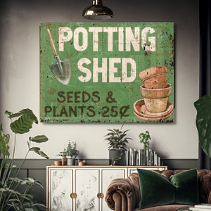 May include: A distressed green sign with the words "Potting Shed" in white. It features a shovel, stacked terracotta pots, and the text "Seeds & Plants 25¢". The sign has a vintage aesthetic.