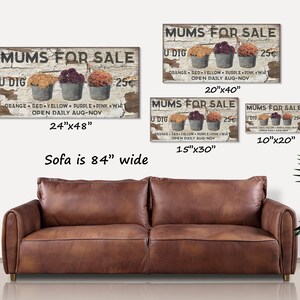 May include: A rustic wooden sign with the text "MUMS FOR SALE" and three metal buckets filled with colorful mums. The sign is available in multiple sizes, including 24"x48", 20"x40", 15"x30", and 10"x20".