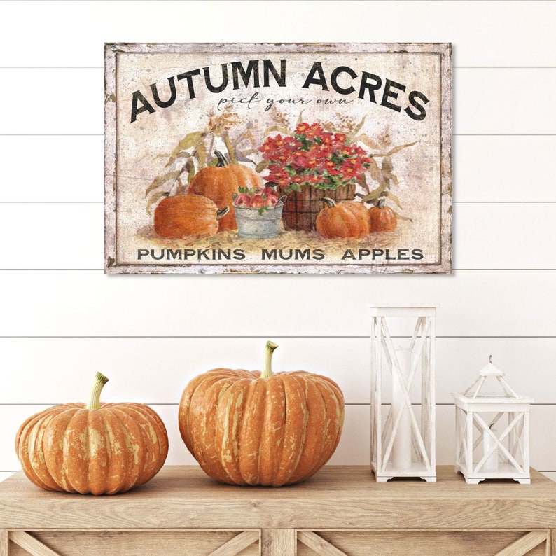 May include: A vintage-style sign with the text "Autumn Acres pick your own PUMPKINS MUMS APPLES" and a painted image of pumpkins, mums, and apples.