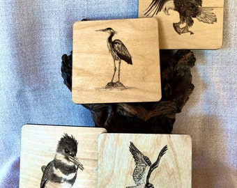 Birds that fish coaster set. Four coaster set with caddy. Gift wrapping available. Free bonus coaster with every purchase.