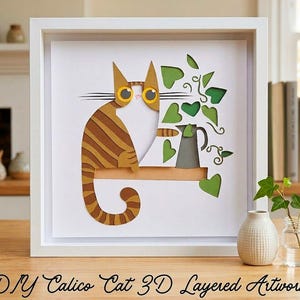 May include: A 3D layered paper artwork in a white square frame featuring a brown tabby cat with large yellow eyes sitting on a shelf next to a gray pitcher and green ivy leaves. The text DIY Calico Cat 3D Layered Artwork is at the bottom.
