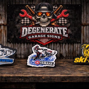 May include: The image showcases three snowmobile-themed patches and a sign. The patches feature the Polaris, Yamaha, and Ski-Doo logos. The sign reads "DEGENERATE GARAGE SIGNS" with a skull graphic. The background is a rustic, corrugated metal wall.