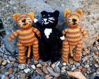 Cat - hand knitted soft toy cats in various cat-like styles, knitted in (mainly) natural fleece-coloured wool