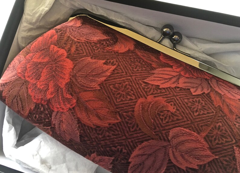burgundy and gold clutch bag