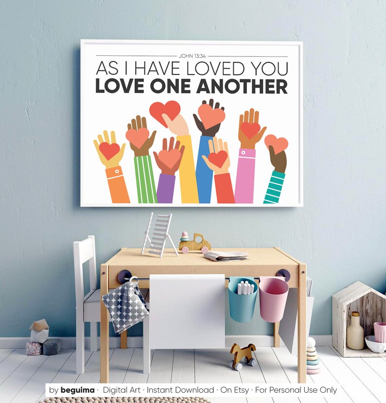 May include: A white poster with the text "JOHN 13:34 AS I HAVE LOVED YOU LOVE ONE ANOTHER" in black. The poster features a colorful illustration of multiple hands holding red hearts.