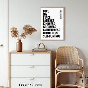 May include: A black and white printable wall art print with the text "LOVE, JOY, PEACE, PATIENCE, KINDNESS, GOODNESS, FAITHFULNESS, GENTLENESS, SELF-CONTROL" and the text "GALATIANS 5:22-23" in a smaller font. The print is framed and hanging on a white wall.