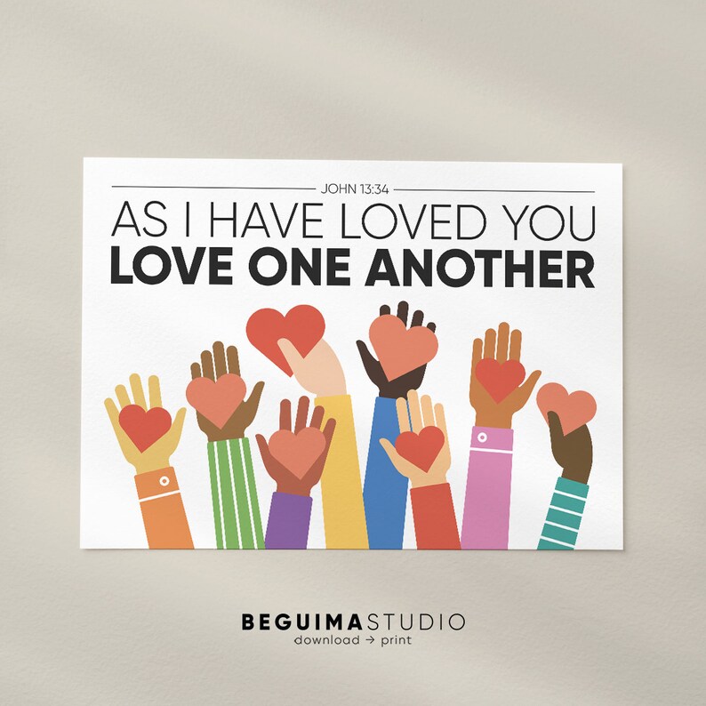 May include: A white printable poster with the text "As I have loved you, love one another" in black bold letters. The text "John 13:34" is in smaller black letters above the main text. The poster features a colorful illustration of multiple hands holding red hearts.