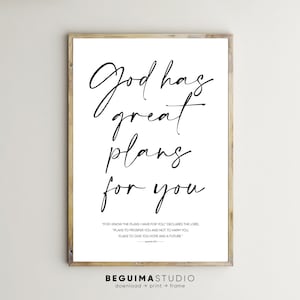 May include: A black and white printable wall art print with a quote about God's plans. The quote reads "God has great plans for you." and includes a Bible verse from Jeremiah 29:11. The print has a white background and black text. The text is in a handwritten font. The print is framed in a light wood frame.