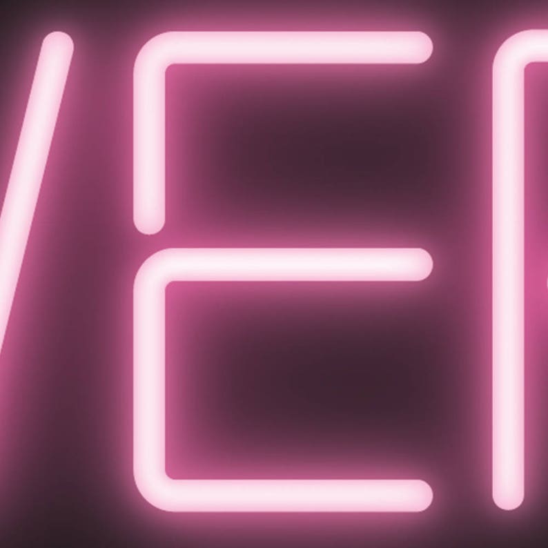 May include: A neon sign displaying the word "EVER" in a bright pink hue. The letters are formed from illuminated tubes, set against a dark backdrop. The font is a clear, sans-serif style, creating a modern and striking visual effect.
