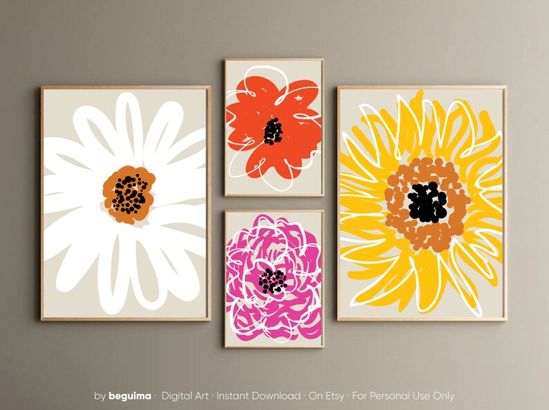 May include: Four framed floral art prints. The prints feature abstract flower designs in white, orange, pink, and yellow on a neutral background. The flowers have black and brown centers. The frames are a light wood color. The bottom of the image has the text "by beguima".