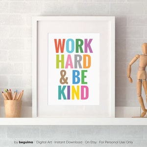 May include: A framed print with the text "WORK HARD & BE KIND" in colorful letters. The letters are stacked vertically and each letter is a different color.