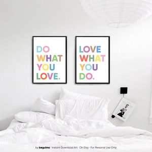 May include: Two framed art prints with black frames and white backgrounds. The left print says "DO WHAT YOU LOVE" in colorful letters. The right print says "LOVE WHAT YOU DO" in colorful letters. The prints are above a bed with white bedding.