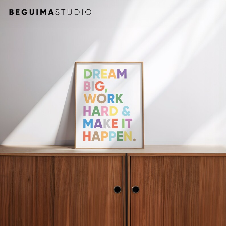 May include: A framed motivational poster with the text "DREAM BIG, WORK HARD & MAKE IT HAPPEN." in colorful letters on a white background.
