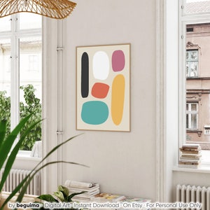 May include: A framed abstract art print featuring a beige background with colorful, irregular shapes in black, white, red-orange, teal, yellow, and magenta. The print is displayed in a light-colored wooden frame. The bottom of the image has the text "by beguima - Digital Art - Instant Download - On Etsy - For Personal Use Only."