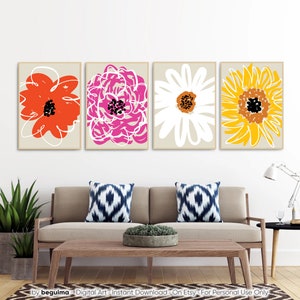 May include: Four framed floral art prints. Each print features a different abstract flower design in vibrant colors: red, pink, white, and yellow. The artwork is set against a neutral background, creating a modern and colorful wall decor.