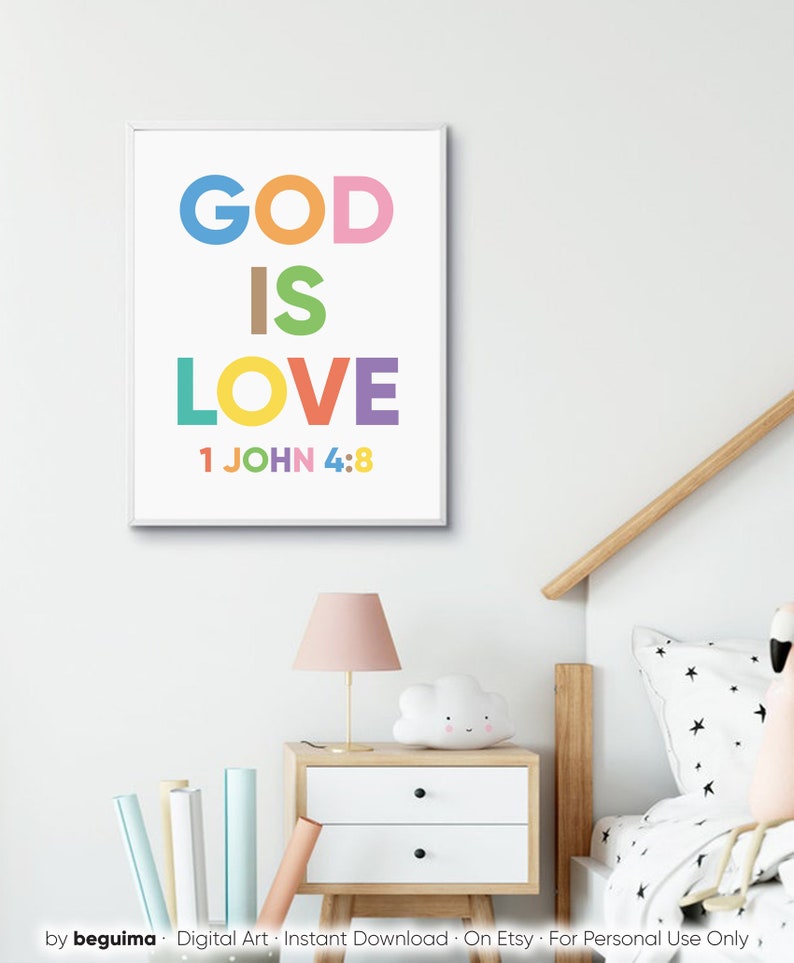 May include: A framed print with the words "GOD IS LOVE" in colorful block letters, with "1 JOHN 4:8" below. The print is displayed above a nightstand with a lamp and cloud-shaped light.