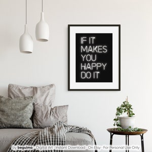 May include: A framed black and white print with the text "IF IT MAKES YOU HAPPY DO IT". The artwork is displayed in a modern living room setting, with neutral-toned pillows and a small side table with a plant.