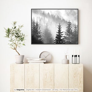May include: A black and white photograph of a misty forest with tall pine trees. The fog is thick and creates a sense of mystery and peace.