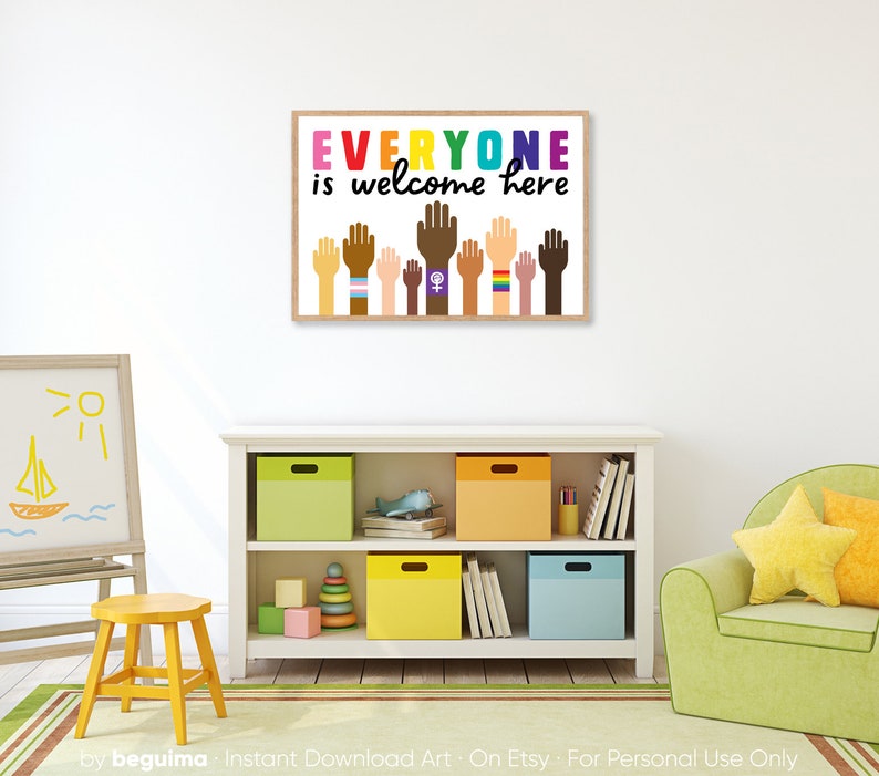 May include: A framed print with the text "EVERYONE is welcome here" in rainbow colours. The print features a row of raised hands of different skin tones, each with a different symbol on their wrist, including a rainbow, a peace sign, and a female symbol.