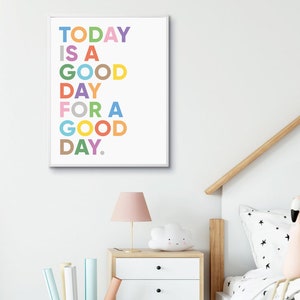 May include: A colorful printable wall art print with the text "TODAY IS A GOOD DAY FOR A GOOD DAY." The text is in a rainbow of colors and is centered on a white background.