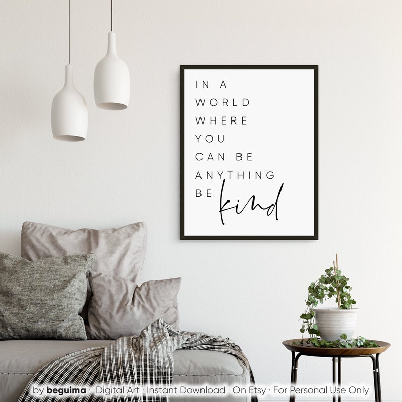 May include: A black and white printable wall art print with the text "In a world where you can be anything be kind".