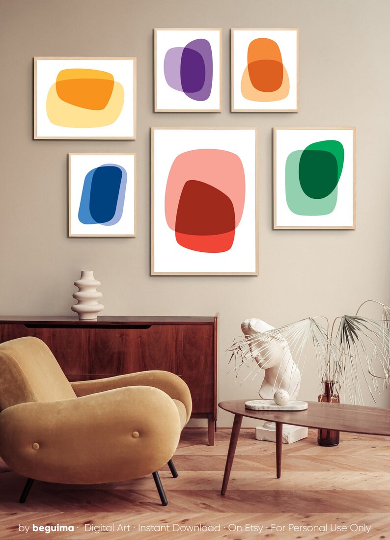 May include: Set of six abstract art prints featuring overlapping geometric shapes in various colors, including red, orange, yellow, green, blue, and purple. The prints are framed and displayed on a wall in a modern living room setting.