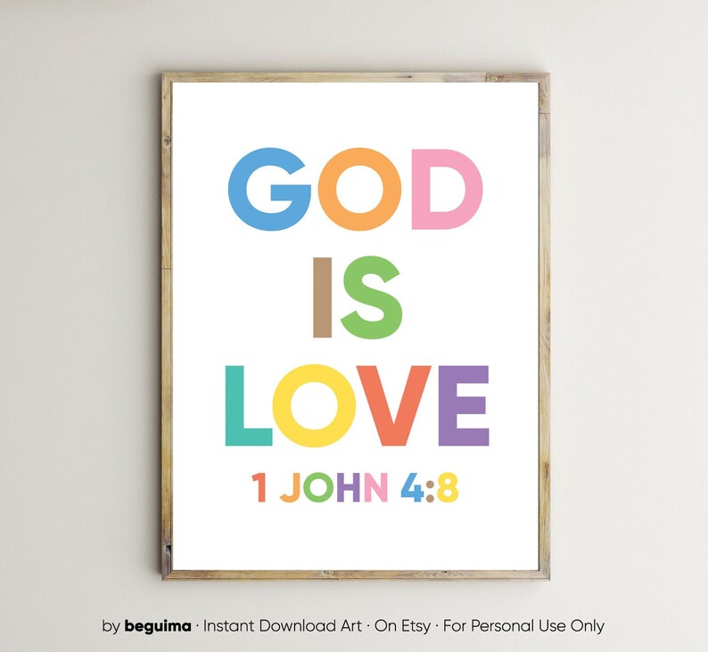 May include: A framed print with the words "GOD IS LOVE" in large, colorful letters. The text "1 JOHN 4:8" is at the bottom. The frame is a light brown color, and the background is white.