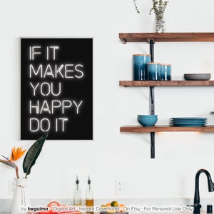 May include: A framed black and white art print with the text "IF IT MAKES YOU HAPPY DO IT". The print is displayed in a modern kitchen setting, alongside wooden shelves with blue ceramic canisters and bowls. A vase with a bird of paradise flower is in the foreground.