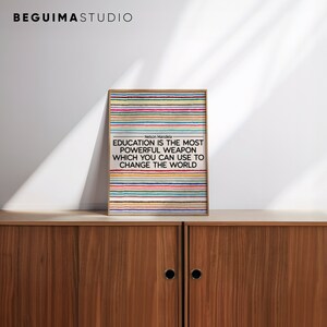 May include: A motivational quote by Nelson Mandela printed on a poster with a colorful striped background. The quote reads "Education is the most powerful weapon which you can use to change the world."