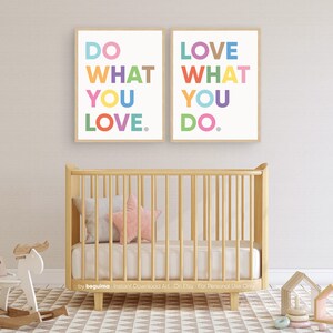 May include: Two framed art prints with the phrases "DO WHAT YOU LOVE" and "LOVE WHAT YOU DO" in colorful block letters. A light wood crib with bedding and a star-shaped pillow is in the foreground. A rocking horse and other toys are also visible.