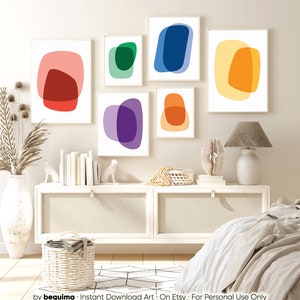 May include: Set of six abstract art prints featuring overlapping circles in various colors, including red, orange, yellow, green, blue, and purple. The prints are displayed on a white wall in a modern bedroom setting.