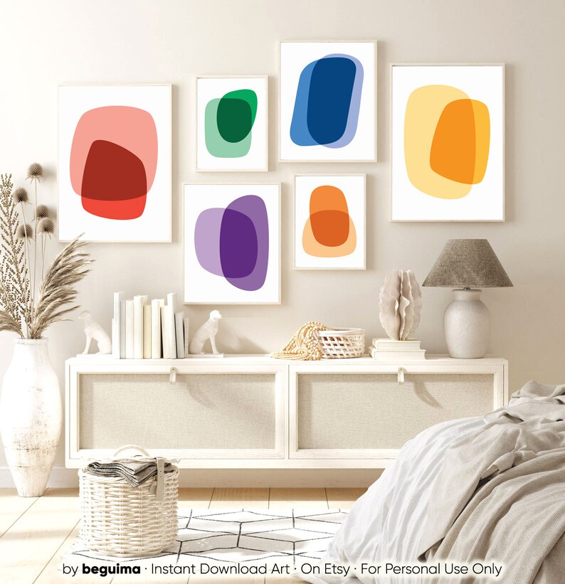 May include: Set of six abstract art prints featuring overlapping circles in various colors, including red, orange, yellow, green, blue, and purple. The prints are displayed on a white wall in a modern bedroom setting.